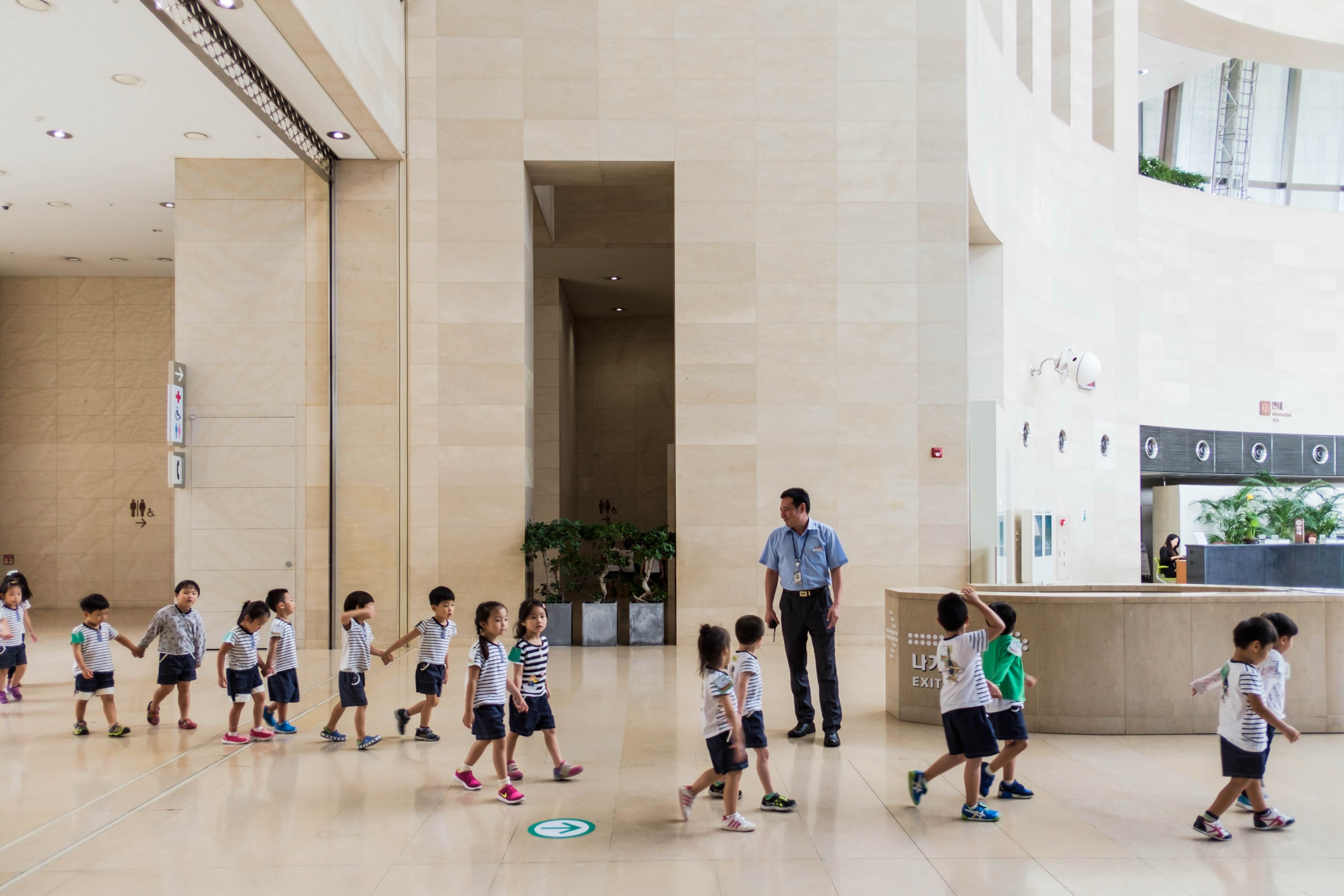 School children crossing the National Museum of Korea's main interior space