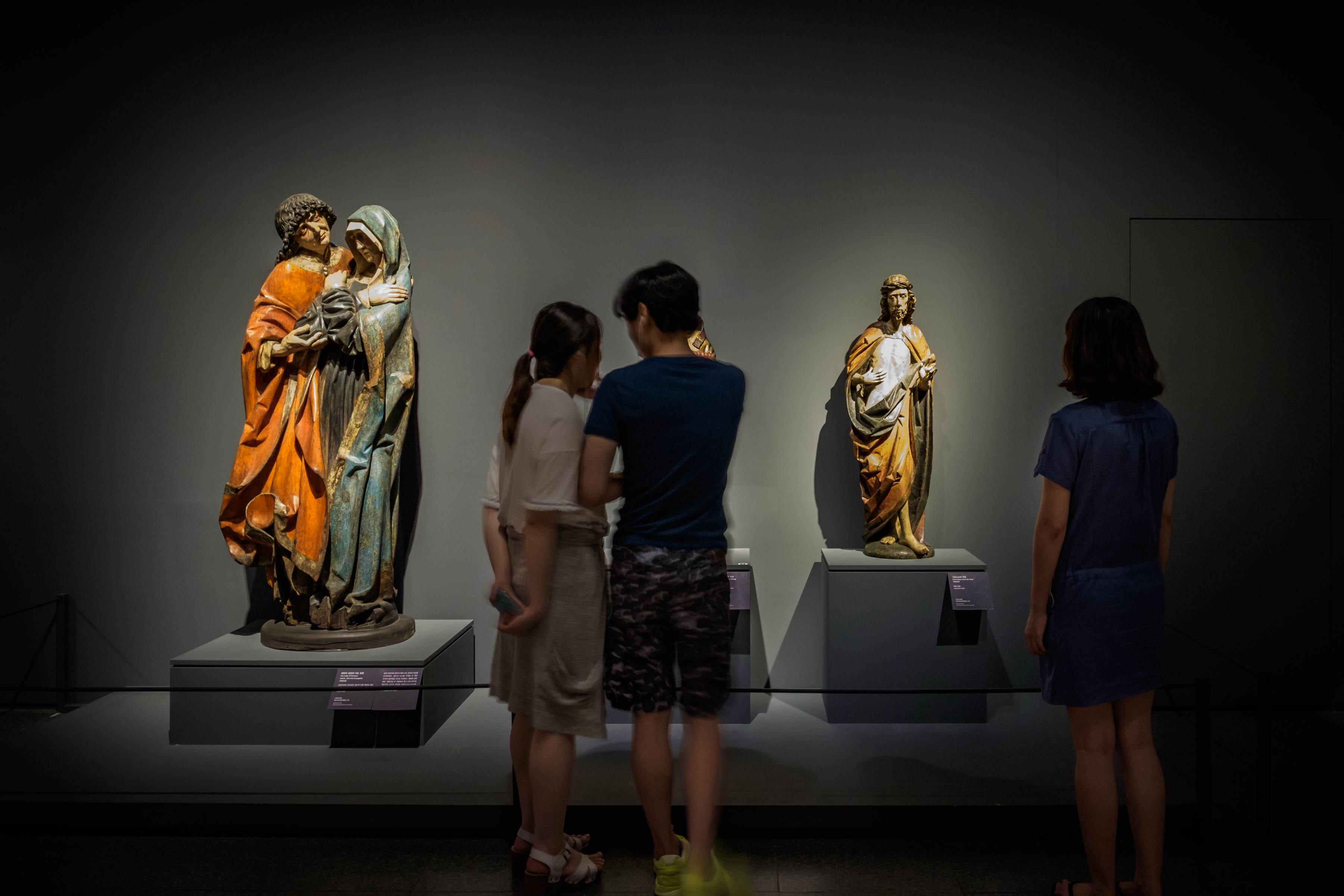 Visitors viewing medieval sculptures at the National Museum of Korea