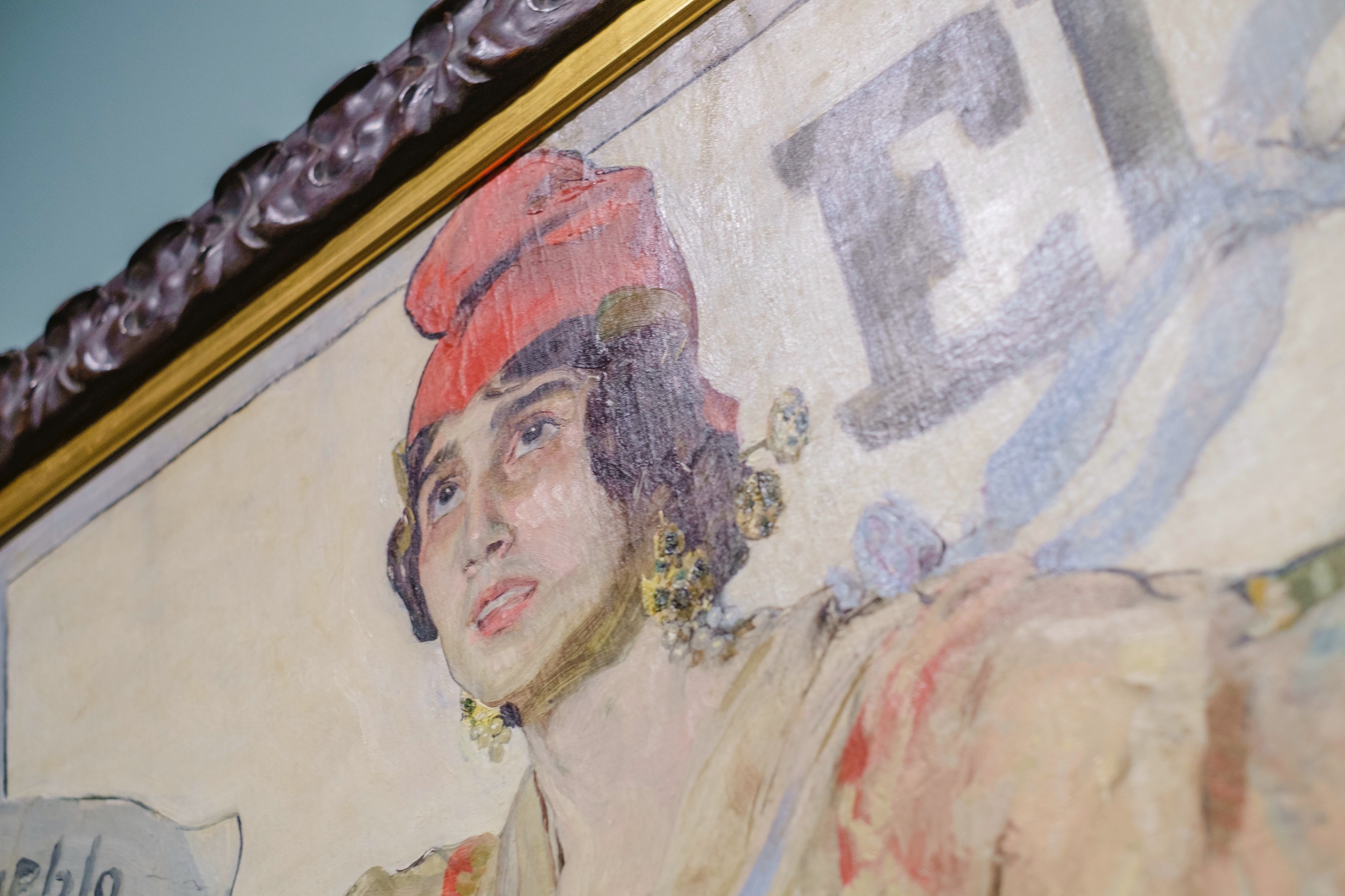 Close detail of a painted woman wearing a head covering