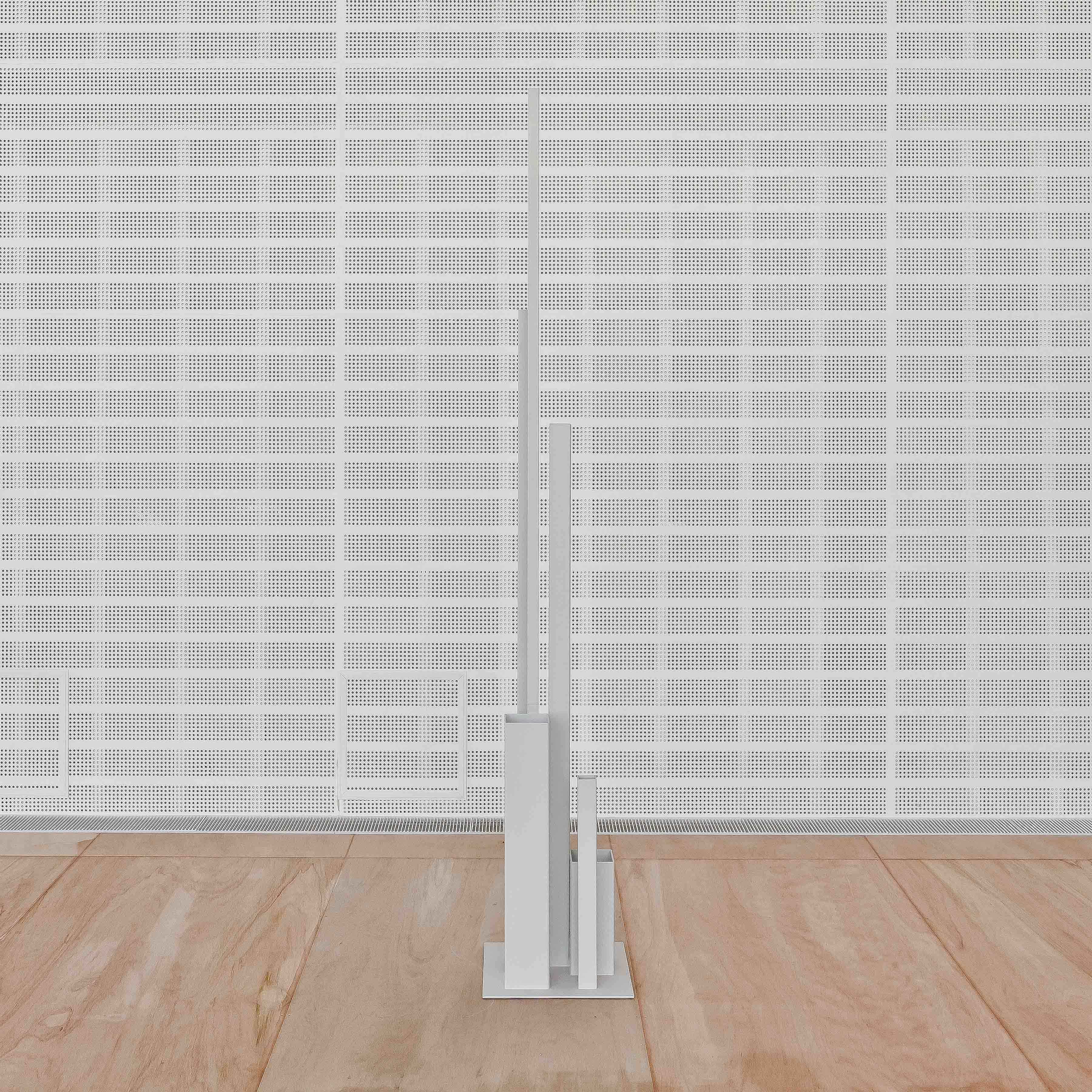 Minimal white sculpture against the perforated glass wall of Espace Louis Vuitton Tokyo