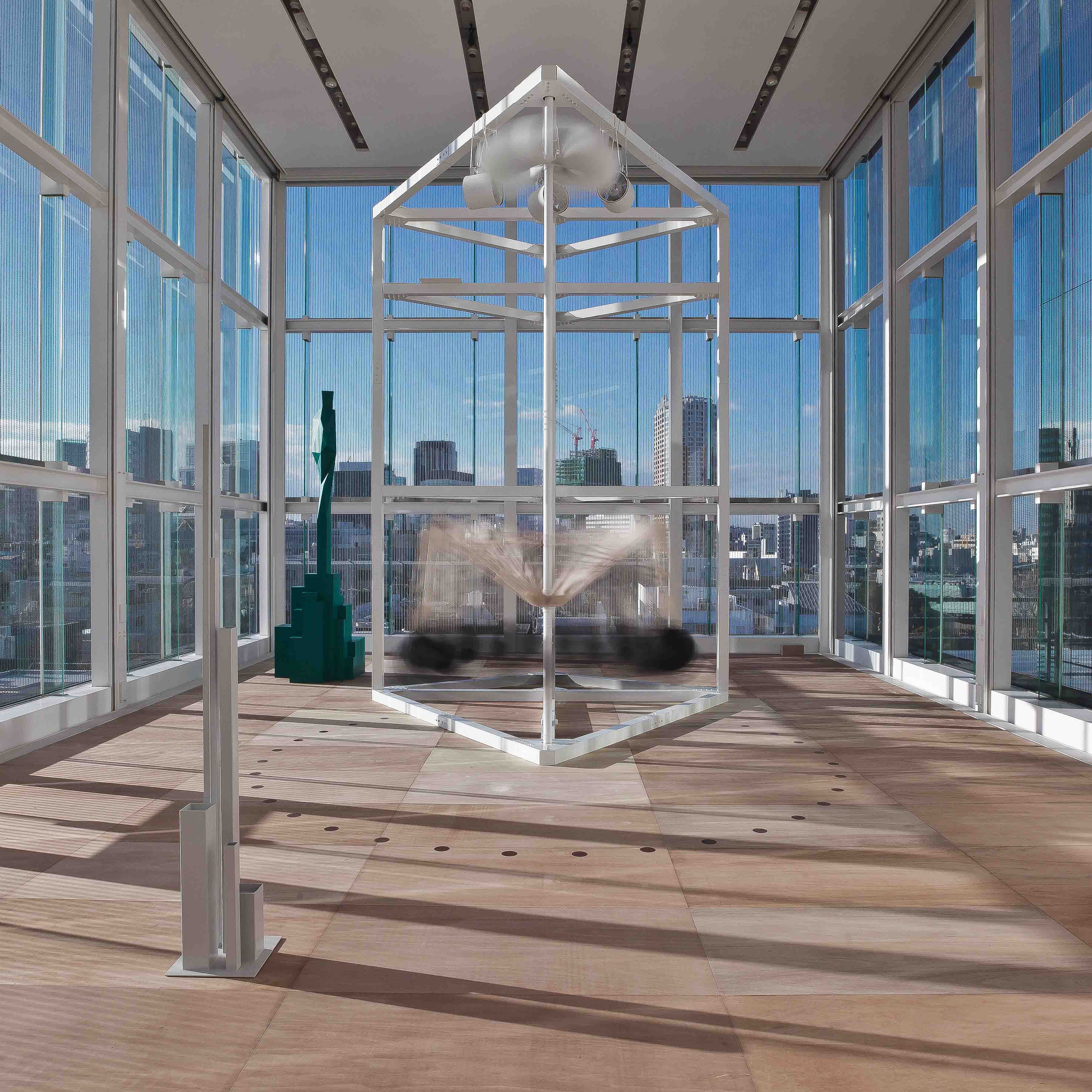 Kinetic Free Fall installation framed against the Tokyo skyline
